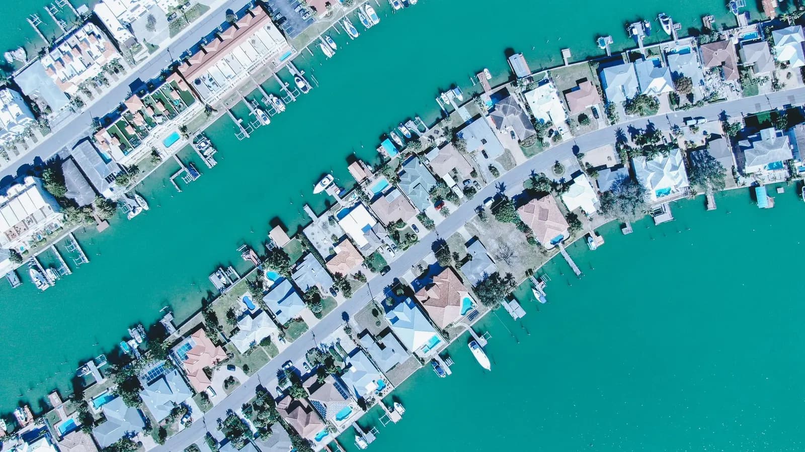 Aerial view of waterfront homes and docks along a canal in South Florida