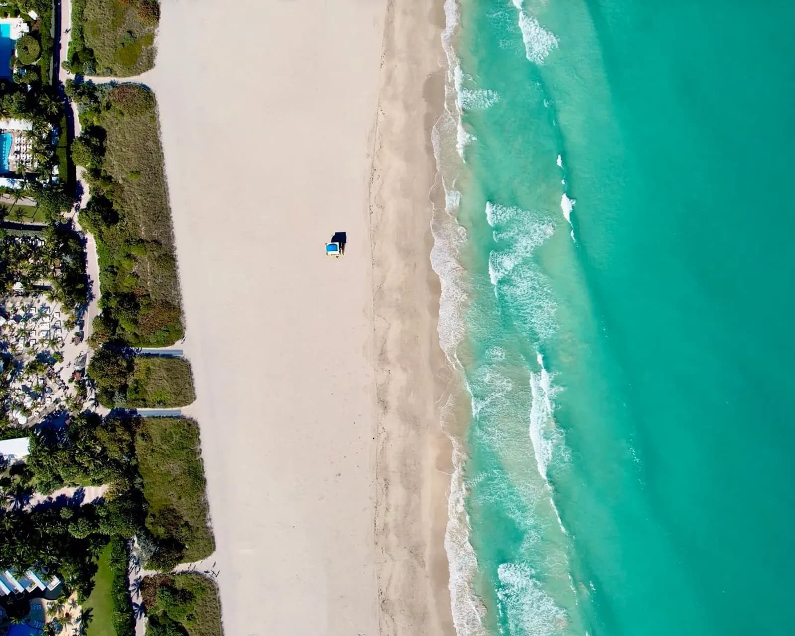 Aerial view of a South Florida beach with high-rise buildings along the ocean